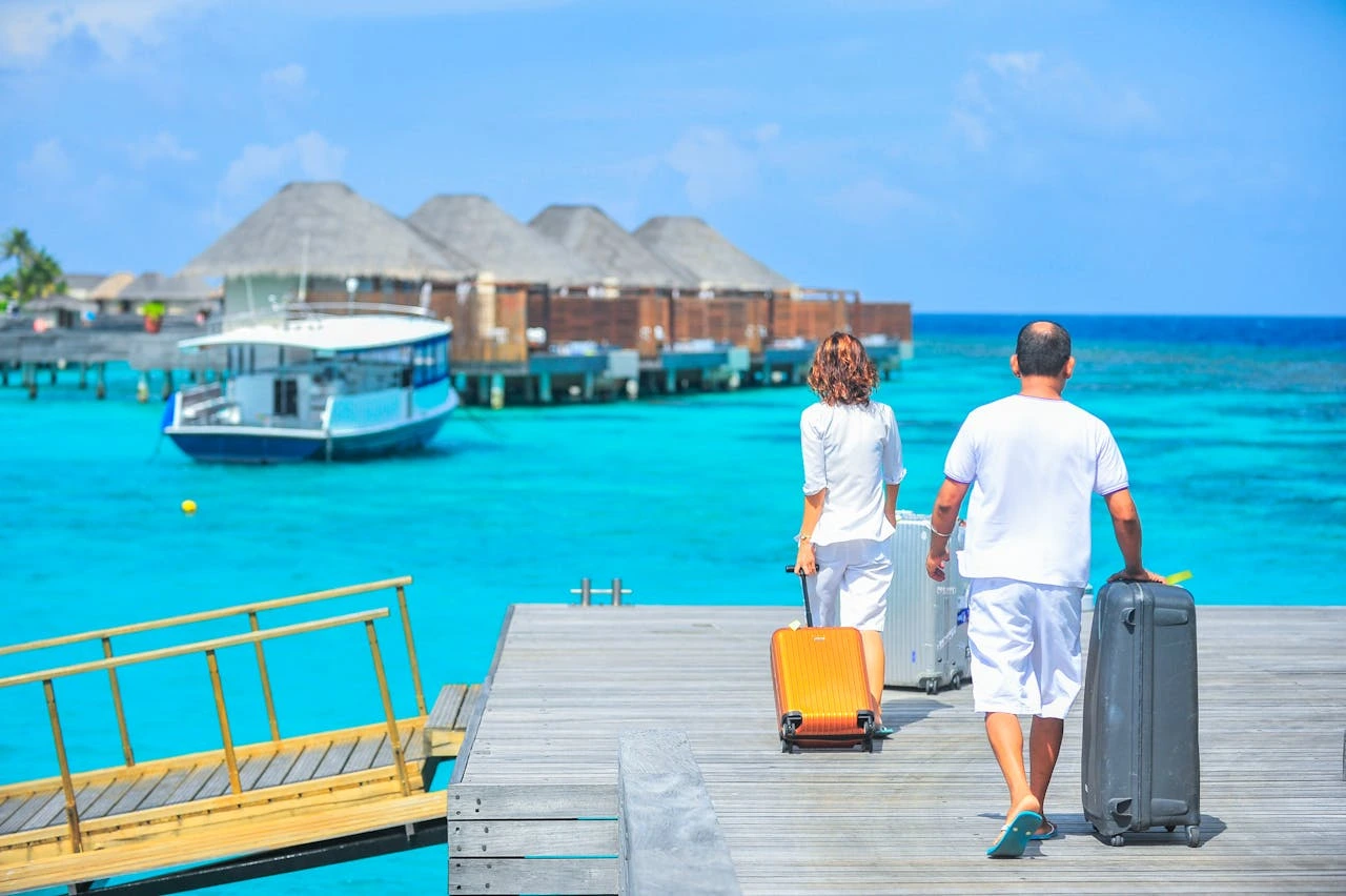 Sunset view from a Baros Maldives water villa with private deck