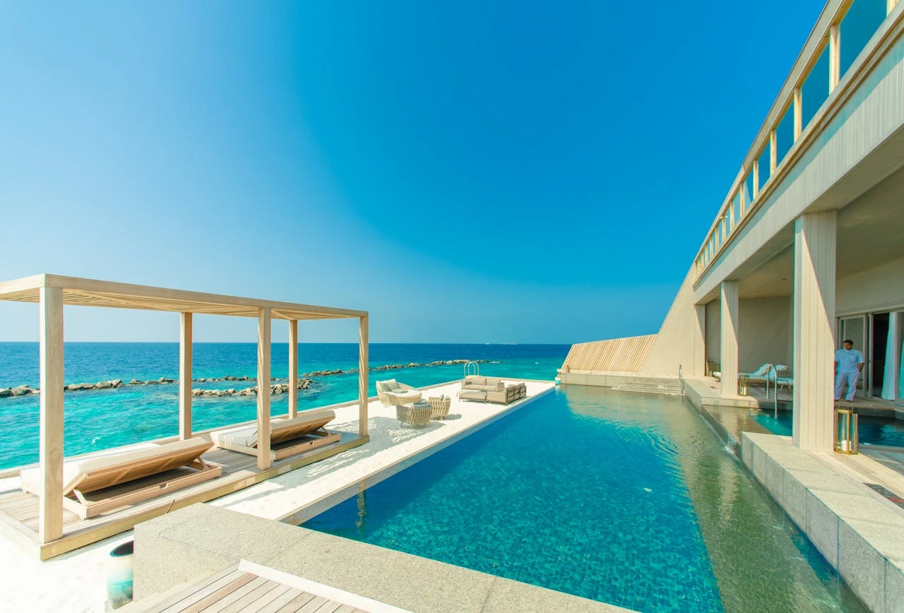 Joali Maldives artist-designed overwater villa and sculpture on the deck