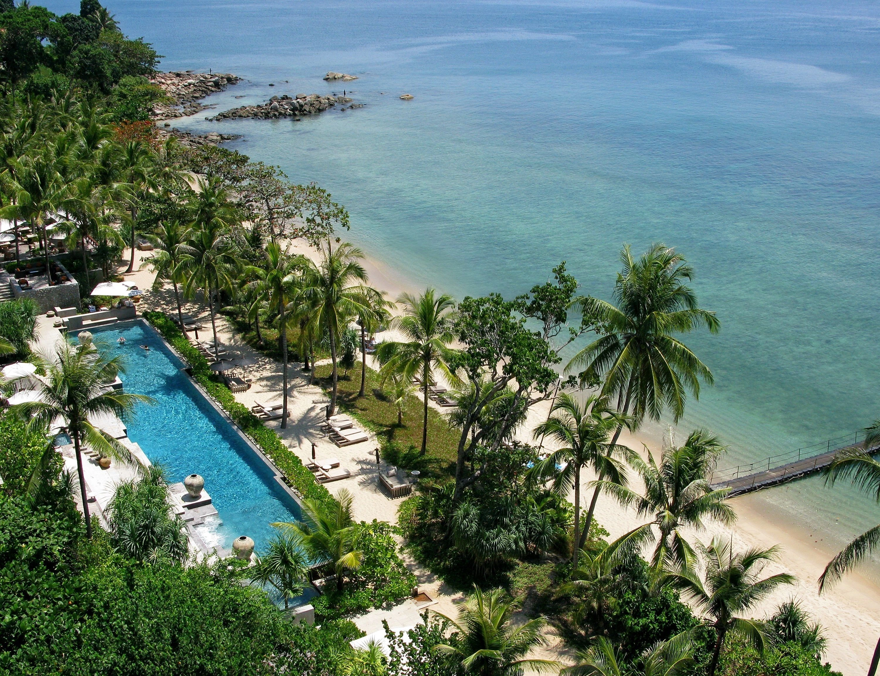 Trisara Villas infinity pool villa  overlooking turquoise ocean under bright sunny sky.