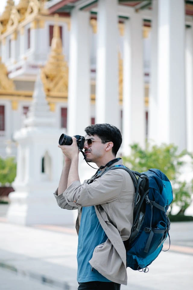 a luxury traveller taking photos of wonders found in Thailand with a travel camera
