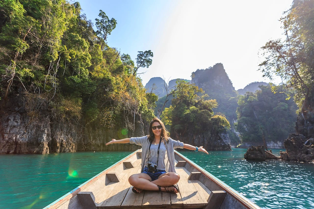 a girl in a boat having an unforgattable luxury experience in thailand riverside